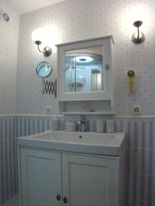 a bathroom with a white sink and a mirror at Your Vacation Retreat Right On The Beach in Casares