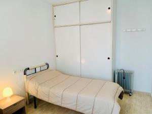a small bedroom with a bed and a closet at A531 - Calasol - 2004 Finestrat s.l. in Cala de Finestrat