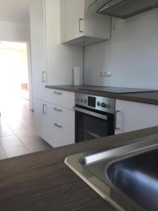 a kitchen with a stove and a sink in it at Mara in Bad Nauheim