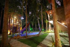 a playground with a slide in a resort at night at Limecabanas-srilanka in Galle