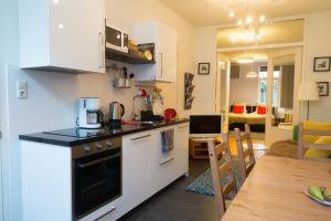 a kitchen with a stove top oven and a microwave at B&B Chez Cho in Utrecht