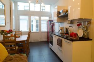 a kitchen with a table and a stove top oven at B&B Chez Cho in Utrecht