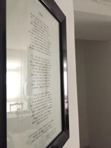 a picture of a poem in a frame on a wall at Itaka in LʼAquila