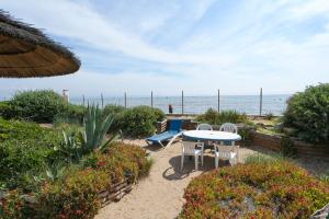 a patio with a table and chairs and the ocean at GRAND SUD in Hyères