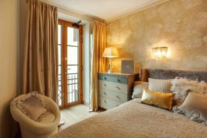 a bedroom with a bed and a chair and a window at Luxury, comfort & quiet place next to Cathedral in Vilnius