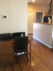 a dining room with a desk and a chair at A Room for You! in Atlanta