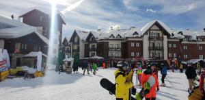 a group of people standing in the snow with snowboards at New Gudauri Loft 1 #440 in Gudauri