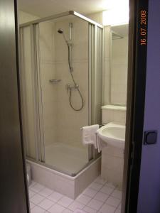 a bathroom with a shower and a sink at Hotel Merkur Garni in Zwickau