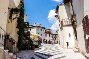 a group of people walking down a street with buildings at Chalet dei Conti in Pescocostanzo