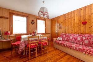 a dining room with a table and chairs at Haus Gobbis Transformational Retreat in the Dolomites in Gosaldo