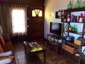 a living room with a television and a table at CASA LA MOLINETA in Arafo