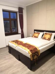 a large bed in a room with a window at Sun-House Pension&Restaurant -ParkingFree- in Prague