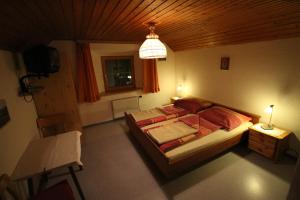 a bedroom with a bed and a chandelier at Ferienwohnung Krennbauer in Öblarn