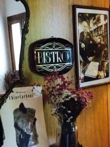 a sign on a wall with a vase with flowers at Locanda San Tomaso in Treviso +57 photos