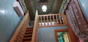 a staircase in a house with a painting on the ceiling at Riad Al Fassia Palace in Fez