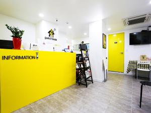 a yellow wall in a store with a yellow door at 24 Guesthouse Seoul City Hall in Seoul