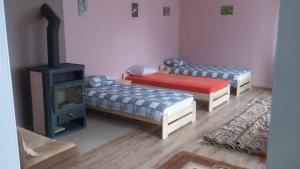 Habitación con 2 camas y estufa de leña. en Chata Rybaka, en Suchowola