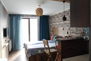 a bedroom with a bed and a brick wall at Love Journey Gudauri in Gudauri