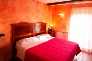 a bedroom with a red bed and a window at Albergo Diffuso Locanda Specchio Di Diana in Nemi