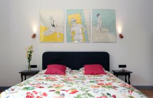 a bedroom with a bed with four pictures on the wall at Sopot Ostsee Apartments in Sopot