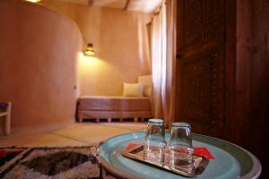 Ένα ή περισσότερα κρεβάτια σε δωμάτιο στο Riad Caravane