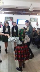 a group of girls dancing in a room at Pensiunea Popan in Şieu