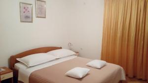 Postel nebo postele na pokoji v ubytování Apartments Pilić