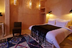 Ένα ή περισσότερα κρεβάτια σε δωμάτιο στο Riad Caravane