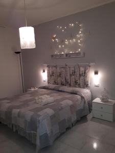 a bedroom with a bed with lights on the wall at Blu Marlin in SantʼAntìoco