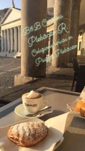 a cup of coffee and a pastry on a table at B&B Carolina Plebiscito R. in Naples