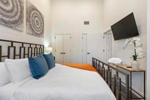 a bedroom with a bed with blue pillows at Luxury City Escape in Newark