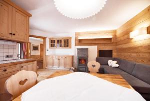 een keuken en een woonkamer met een bed en een bank bij Villa Schmalzl in Ortisei +22 foto's