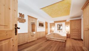 Villa Schmalzl في أورتيساي: غرفة نوم بها منور كبير وجدران خشبية