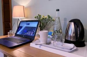 a laptop computer sitting on top of a wooden desk at Hope Orchard En-Suite Rooms in Cheltenham