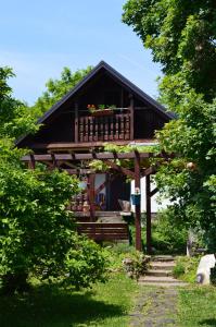 a house with a porch with a balcony at Na Okić - a private forest oasis in Sveti Martin pod Okićem