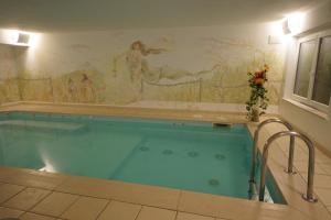 a large swimming pool with a mural on the wall at Residence Baita Antlia in Arabba