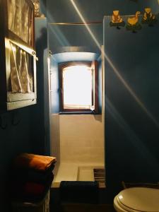 a bathroom with a toilet and a window at Bed And Breakfast Dopo Il Settimo Cielo in Lubriano