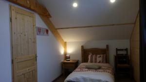 a bedroom with a bed in a attic at Gite châlet nature haute vosges in Anould +42 photos