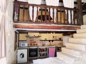 a room with a staircase with a washer and dryer at Casa Marina in Valderrobres