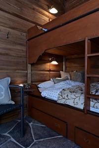 a bedroom with a bunk bed and a chair at Noreheim in Noresund