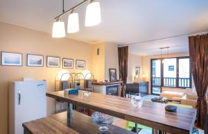 a kitchen and living room with a table and a refrigerator at Mountain Escape Bansko 1BR apartment in Bansko