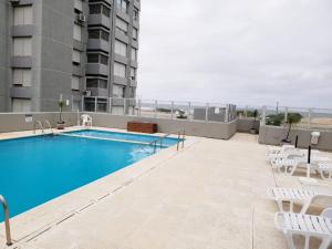 a swimming pool on the roof of a building at Departamento frente al mar in Punta del Este +12 photos