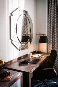 an office with a desk with a chair and a mirror at Mercure Bridgwater in Bridgwater