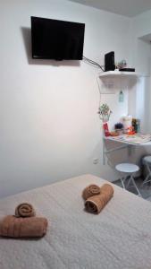 a bedroom with a bed with two towels on it at Ruby room in Zagreb