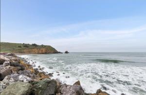 a group of rocks on the shore of a beach at @ Marbella Lane Top Coastline Views, Family Friendly in Pacifica