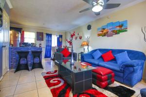 a living room with a blue couch and a table at The Oasis I, Portmore Country Club in Portmore