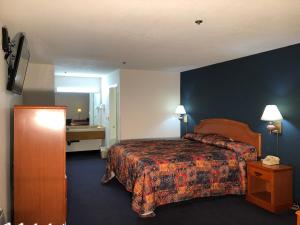 Habitación de hotel con cama y escritorio en Luxury Inn en Norwalk