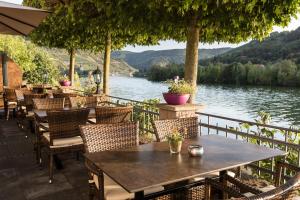 een tafel en stoelen met uitzicht op een meer bij Hotel garni "Café im Hamm" in Zell an der Mosel