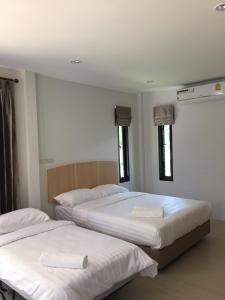 Giường trong phòng chung tại Bulan Villa rayong