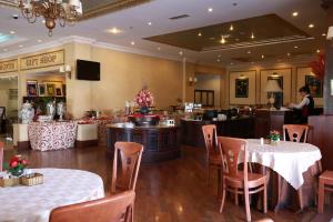 a restaurant with tables and chairs and a counter at Sammy Dalat Hotel in Da Lat